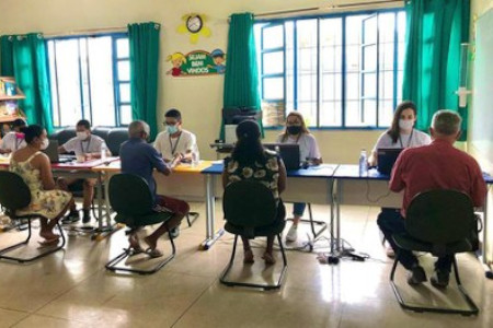 Foto de uma sala mostra pessoas sendo atendidas pela equipe do TRE-TO.