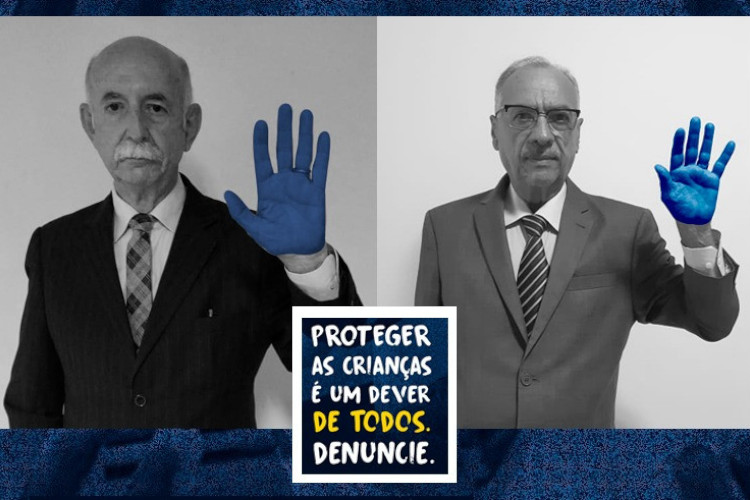 Composição de fotos de dois magistrados do TJBA com a mão esquerda levantada, pintada de azul, símbolo da campanha da Amaerj. Texto: Proteger as crianças é um dever de todos. Denuncie.