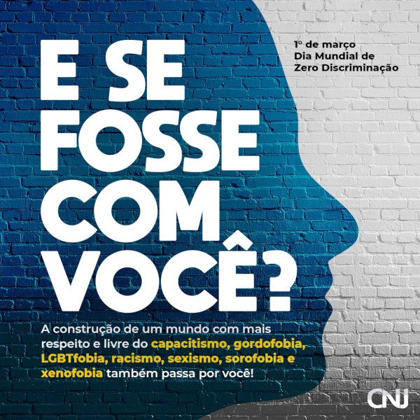 Ao fundo, parede de tijolos com pintura branca com silhueta azul de rosto em perfil sobreposta a parede. Texto: “E se fosse com você? A construção de um mundo com mais respeito e livre do capacitismo, gordofobia, LGBTfobia racismo, sexismo, sorofobia e xenofoia também passa por você. 1° de março - Dia Mundial de Zero Discriminação."