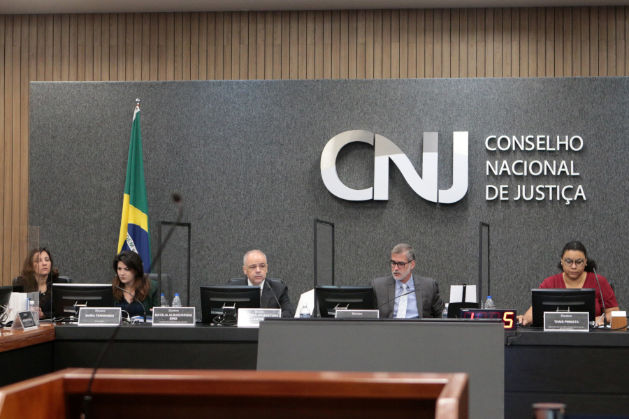 Foto mostra bancada principal do Plenário do CNJ com algumas pessoas participantes da reunião.