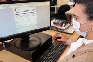 Foto mostra uma mulher em frente a um computador preenchendo o formulário do repositório de mulheres juristas do TJPA.